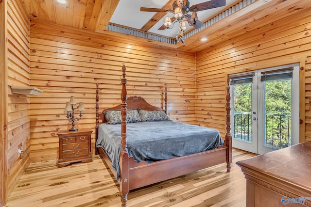 bedroom featuring a towering ceiling, access to outside, light wood-type flooring, and ceiling fan