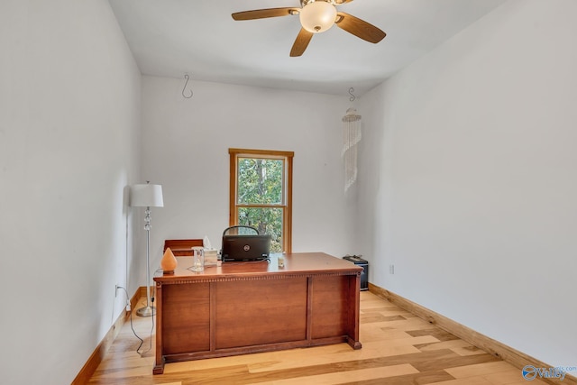 home office with light hardwood / wood-style flooring and ceiling fan