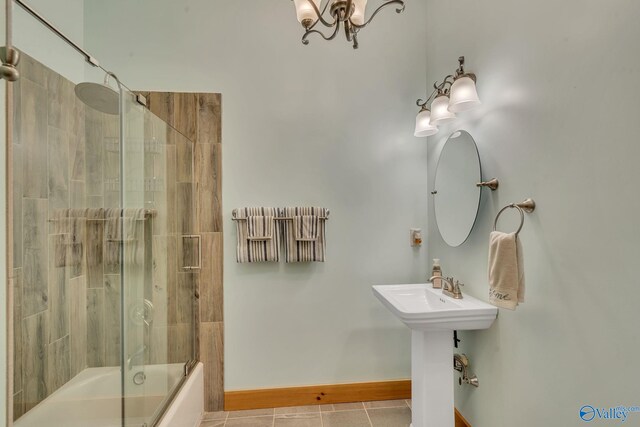 bathroom with sink, enclosed tub / shower combo, and tile patterned flooring