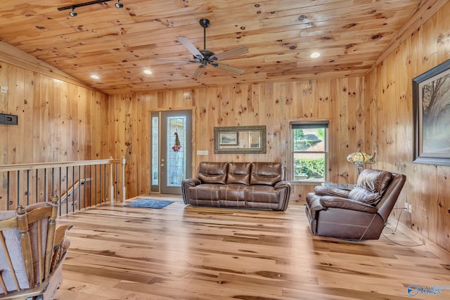 living room featuring wooden walls, wooden ceiling, and light wood-type flooring