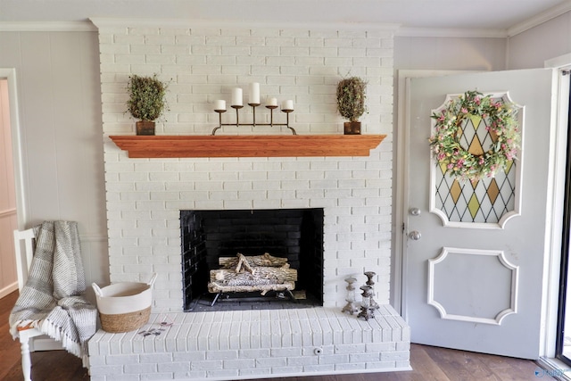details featuring ornamental molding, wood finished floors, and a fireplace