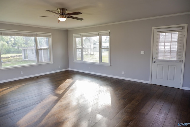 unfurnished room featuring dark wood-type flooring, a ceiling fan, baseboards, and ornamental molding