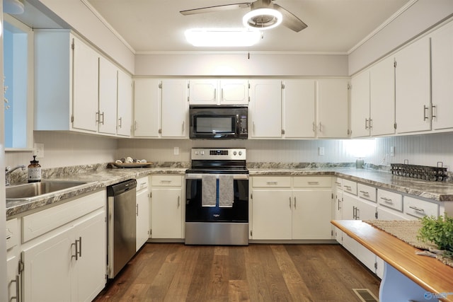 kitchen featuring white cabinets, ceiling fan, appliances with stainless steel finishes, a sink, and ornamental molding