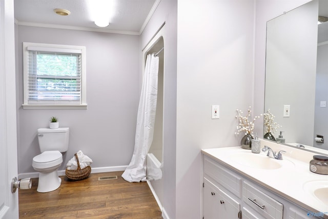 bathroom with visible vents, wood finished floors, a sink, toilet, and ornamental molding