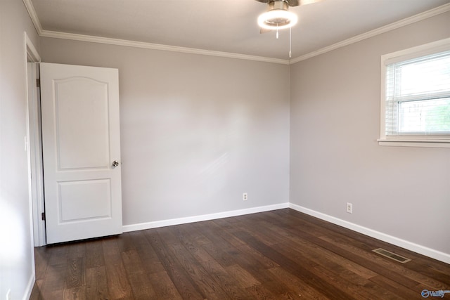 empty room with crown molding, visible vents, baseboards, ceiling fan, and dark wood-style floors