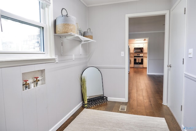 laundry area with laundry area, hookup for a washing machine, wood finished floors, visible vents, and ornamental molding