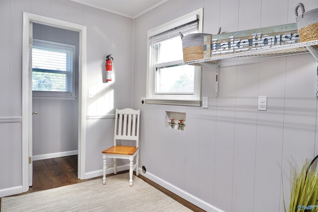 clothes washing area with washer hookup, laundry area, electric dryer hookup, wood finished floors, and baseboards