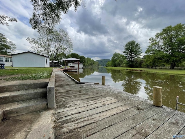 view of dock with a water view and a gazebo