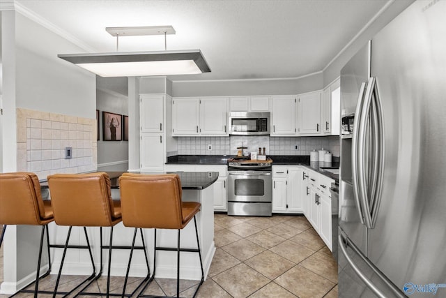 kitchen with dark countertops, white cabinetry, and stainless steel appliances