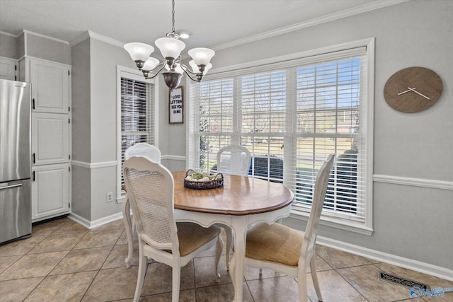dining room featuring a notable chandelier, light tile patterned floors, baseboards, visible vents, and ornamental molding