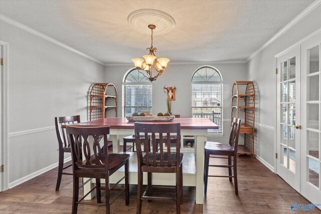 dining room with french doors, wood finished floors, a chandelier, and crown molding