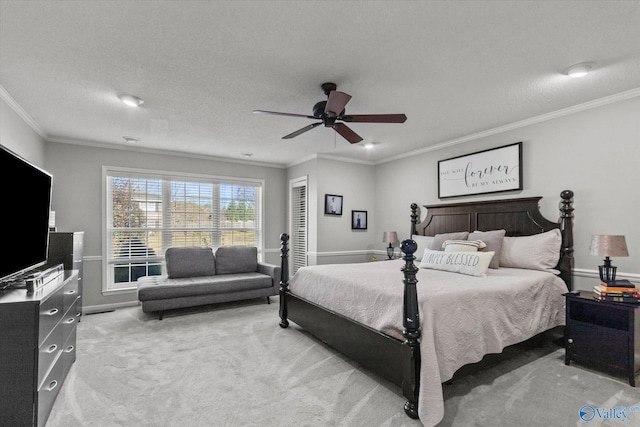 bedroom with light carpet, crown molding, ceiling fan, and a textured ceiling