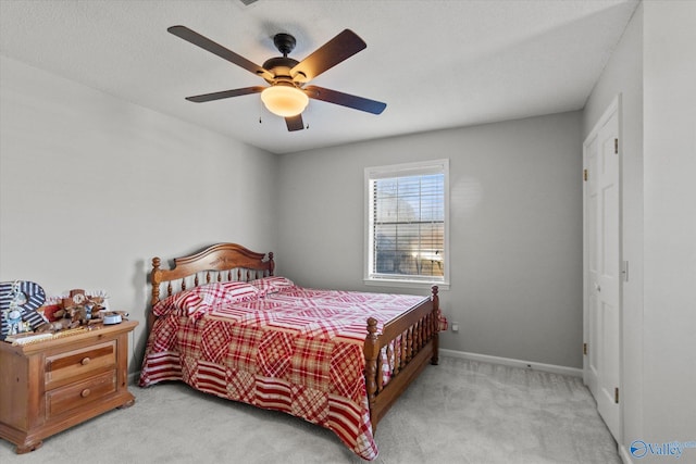 bedroom featuring baseboards, carpet floors, and a ceiling fan