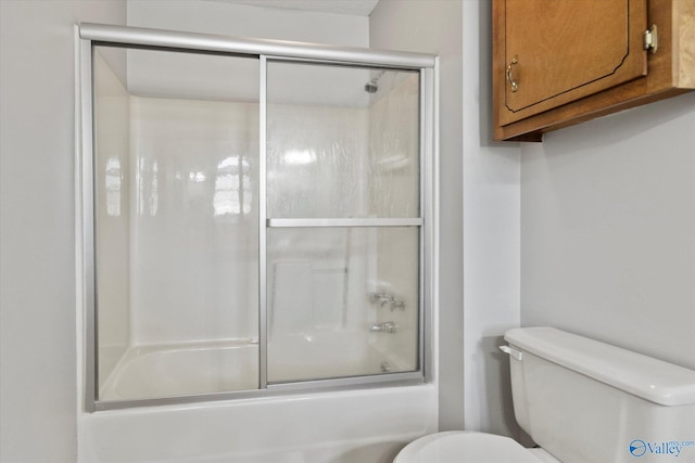 full bath with toilet and combined bath / shower with glass door