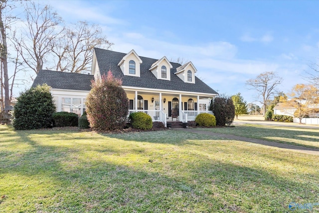 cape cod home with covered porch, a front lawn, and roof with shingles