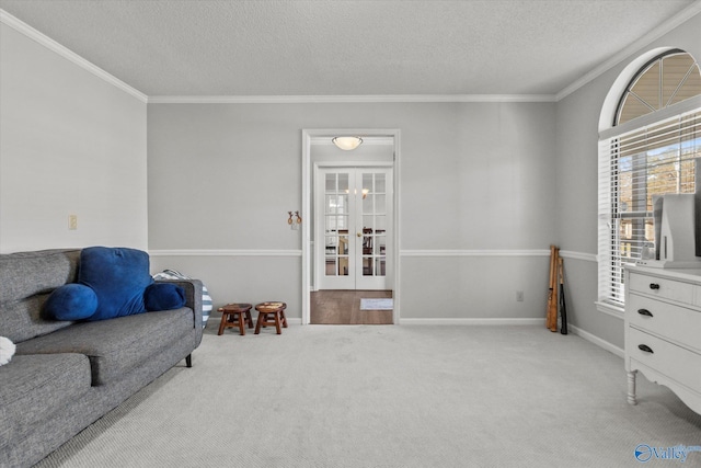 living area featuring a textured ceiling, carpet floors, ornamental molding, and french doors