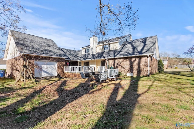 back of house featuring driveway, covered porch, a chimney, brick siding, and a garage