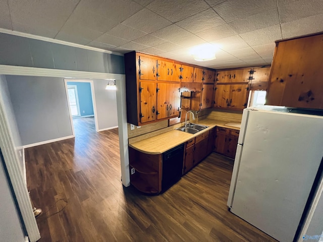1315 Colbert Ave, Gadsden, AL 35904 - kitchen with crown molding, freestanding refrigerator, light countertops, dark wood finished floors, and brown cabinetry