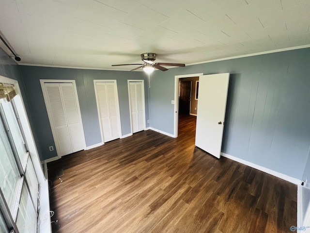 1315 Colbert Ave, Gadsden, AL 35904 - unfurnished bedroom featuring wood finished floors, multiple closets, ornamental molding, ceiling fan, and multiple windows