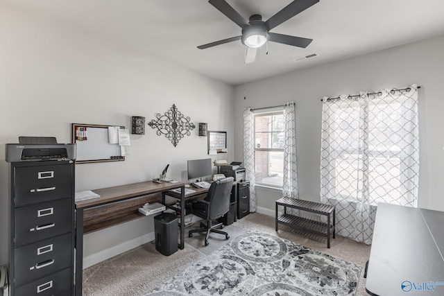 carpeted office space with ceiling fan