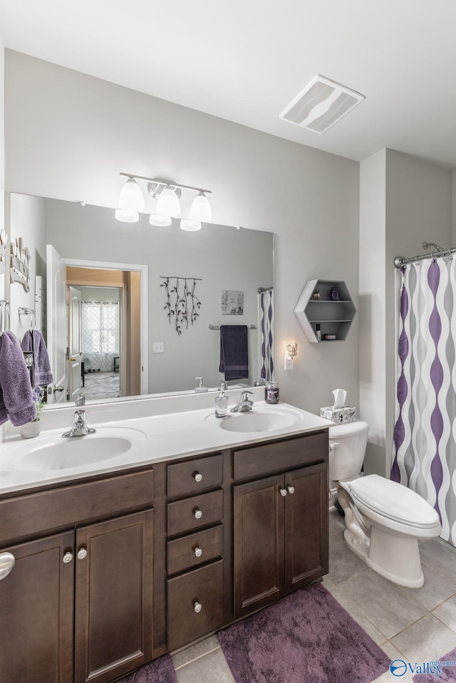 bathroom featuring tile patterned floors, vanity, and toilet