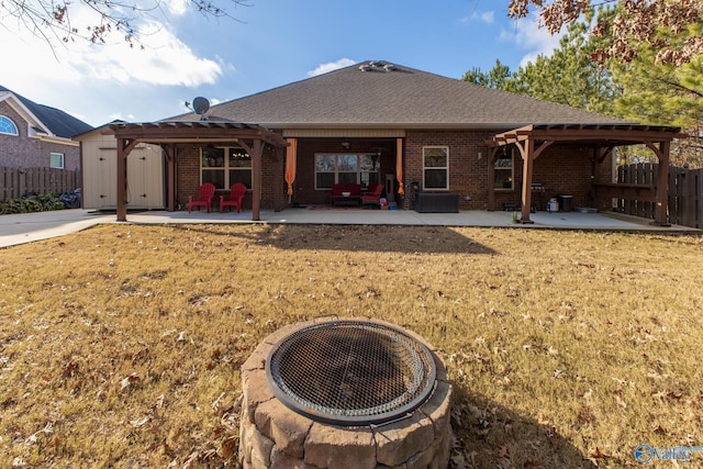 rear view of house featuring a patio, a pergola, and a fire pit