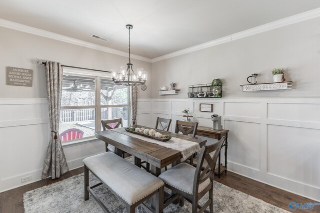 dining area with a notable chandelier, dark hardwood / wood-style floors, and ornamental molding