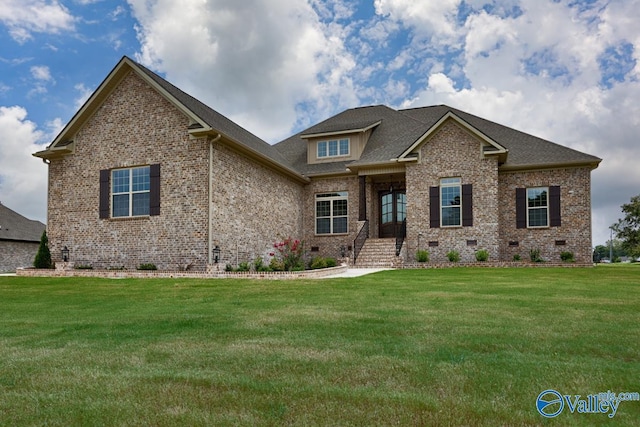 view of front facade with a front yard, brick siding, roof with shingles, and crawl space