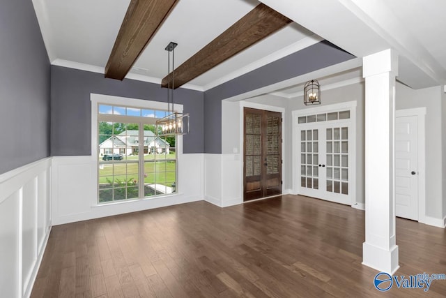 unfurnished dining area with beam ceiling, dark wood-type flooring, and an inviting chandelier