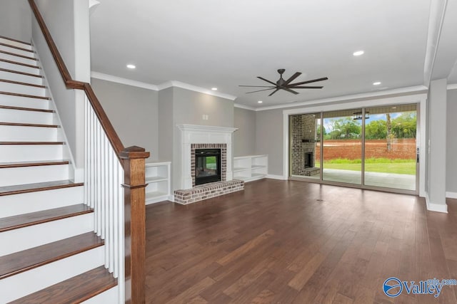 unfurnished living room featuring ceiling fan, a fireplace, ornamental molding, and hardwood / wood-style flooring