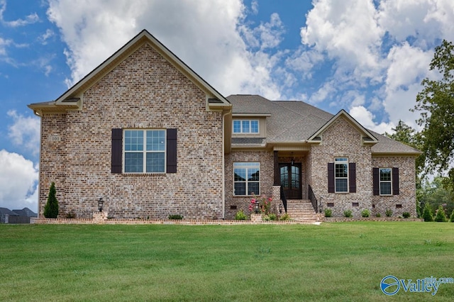 view of front facade featuring a front lawn, brick siding, roof with shingles, and crawl space