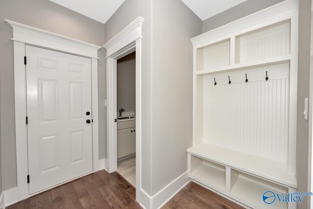 entryway with dark wood-type flooring, a barn door, crown molding, a notable chandelier, and french doors