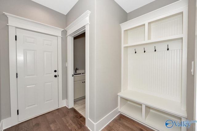 mudroom with a sink, baseboards, and dark wood-style floors