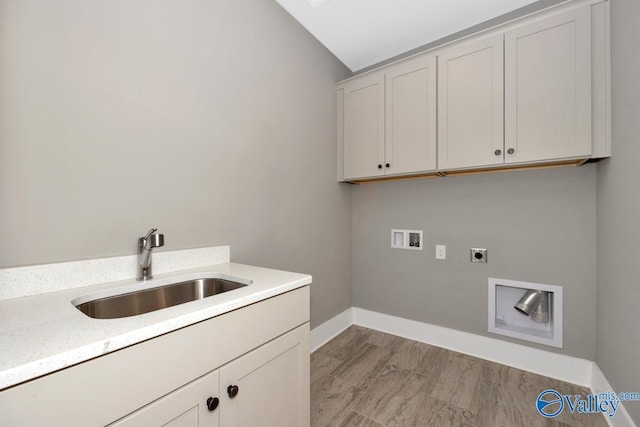 laundry room featuring hookup for a washing machine, baseboards, hookup for an electric dryer, cabinet space, and a sink