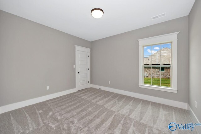 empty room with ceiling fan, a raised ceiling, and a healthy amount of sunlight