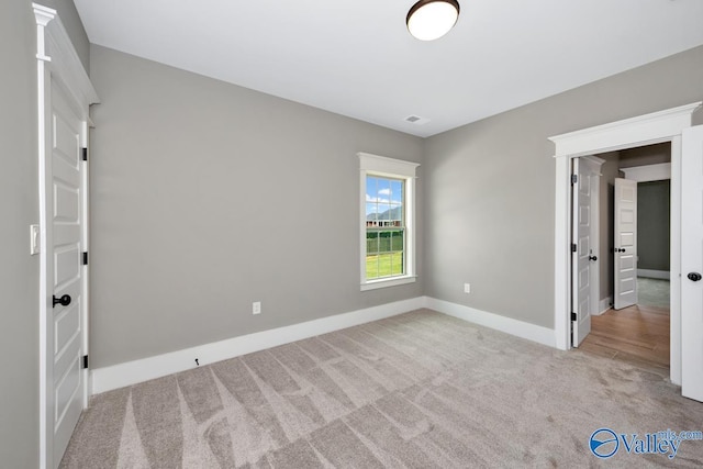 unfurnished bedroom with visible vents, baseboards, and carpet floors