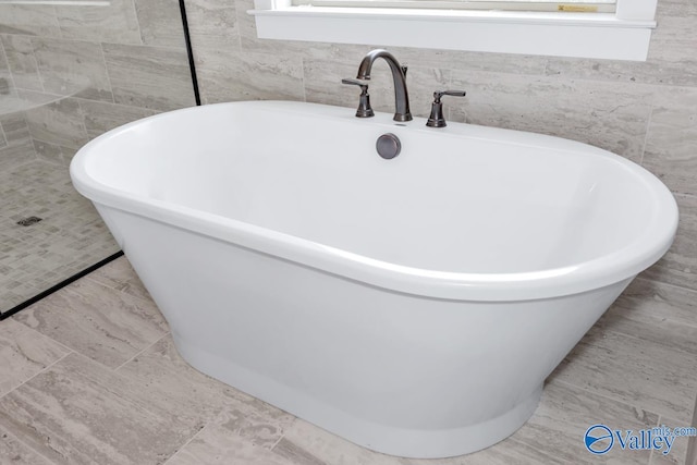 bathroom featuring tile patterned floors and tile walls