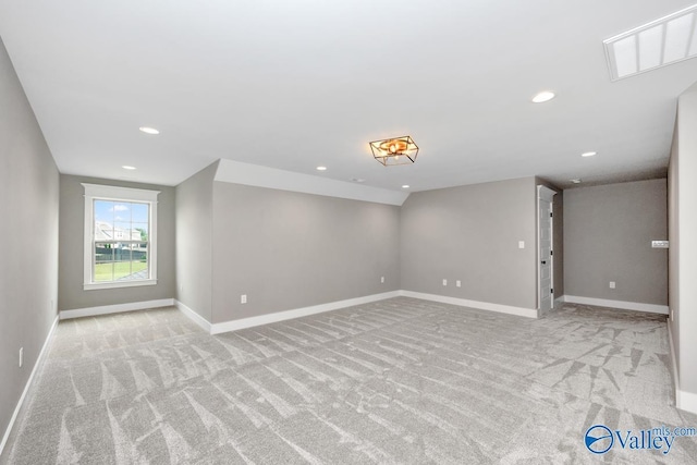 carpeted spare room with recessed lighting and baseboards