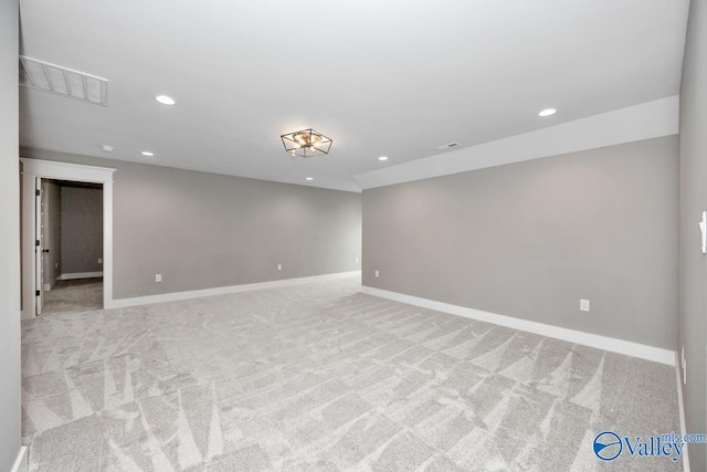 empty room with light carpet, visible vents, recessed lighting, and baseboards