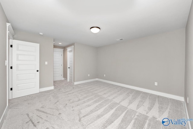 carpeted spare room with baseboards and visible vents