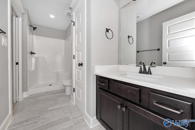 full bathroom with vanity, visible vents, baseboards, a shower, and toilet