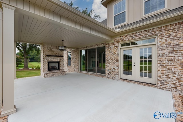 view of patio featuring french doors and an outdoor brick fireplace