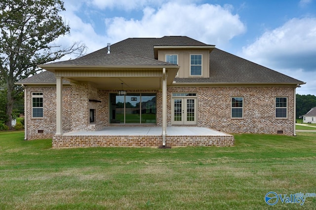 rear view of house with crawl space, a patio, brick siding, and a yard