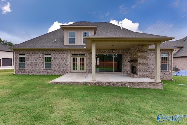 back of house with french doors, a patio area, and a yard