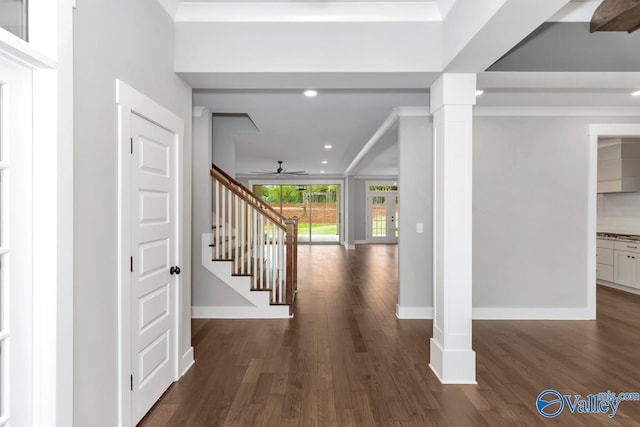 corridor with hardwood / wood-style flooring and ornate columns