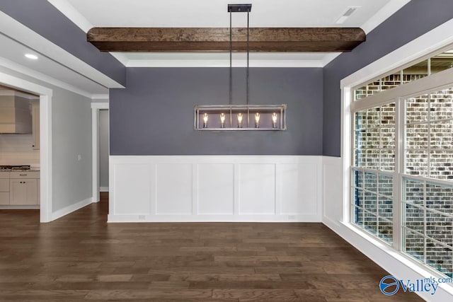 unfurnished dining area featuring beam ceiling, crown molding, and dark wood-type flooring