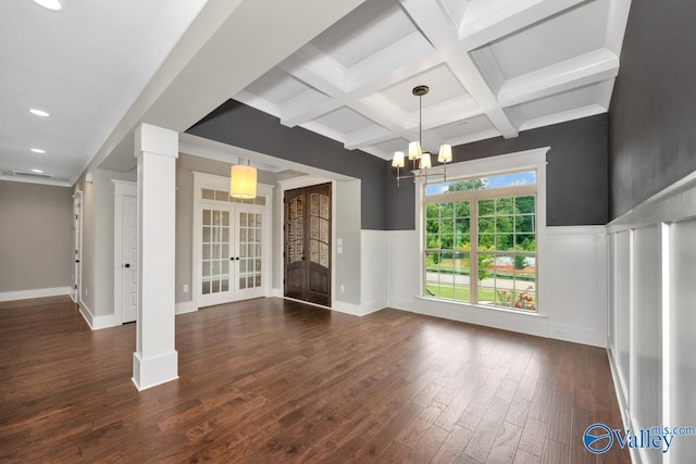 interior space featuring a wainscoted wall, beam ceiling, coffered ceiling, dark wood finished floors, and french doors