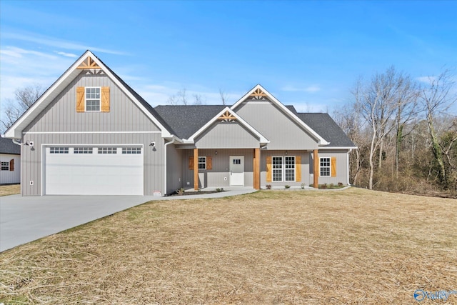 view of front of home featuring a garage, a front lawn, and a porch