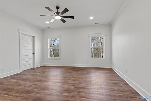 empty room with plenty of natural light, dark hardwood / wood-style floors, and ornamental molding