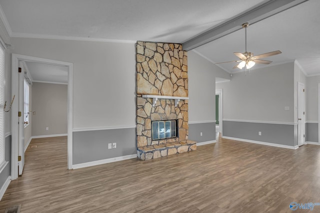 unfurnished living room featuring ornamental molding, wood-type flooring, a fireplace, and vaulted ceiling with beams